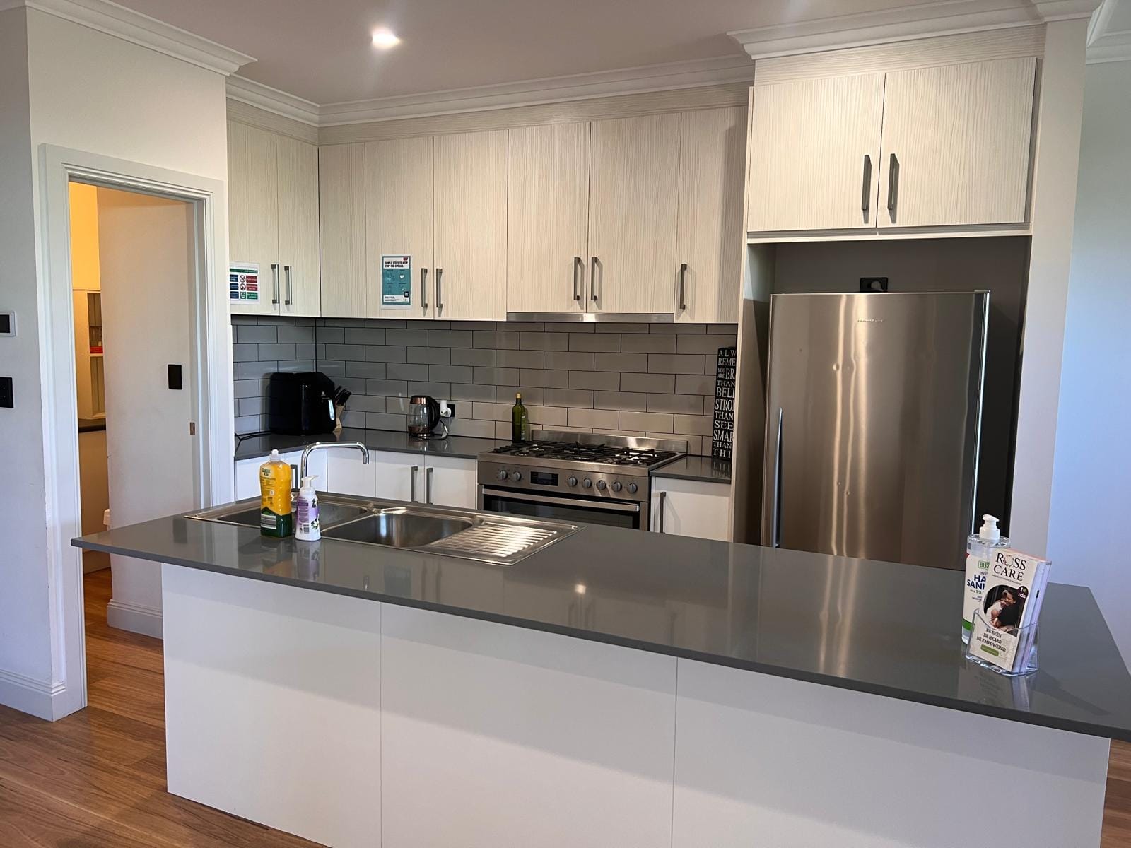 Modern kitchen featuring white cabinetry and black countertops.